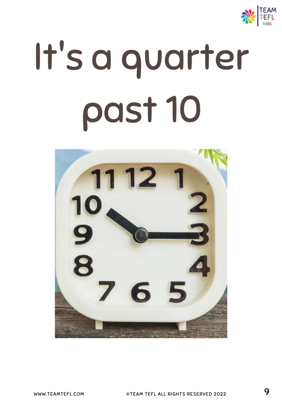 It's a quarter past 10 flashcard: photo of a desk clock with the minute hand on 3 and the hour hand just past 10