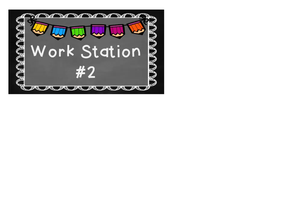 Work Station #2 sign in white chalk lettering on a grey chalkboard, topped with a string of rainbow pencil pennants