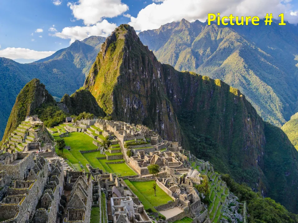 Picture # 1: Machu Picchu ruins with stone buildings and farming terraces below steep green peaks, for photo analysis