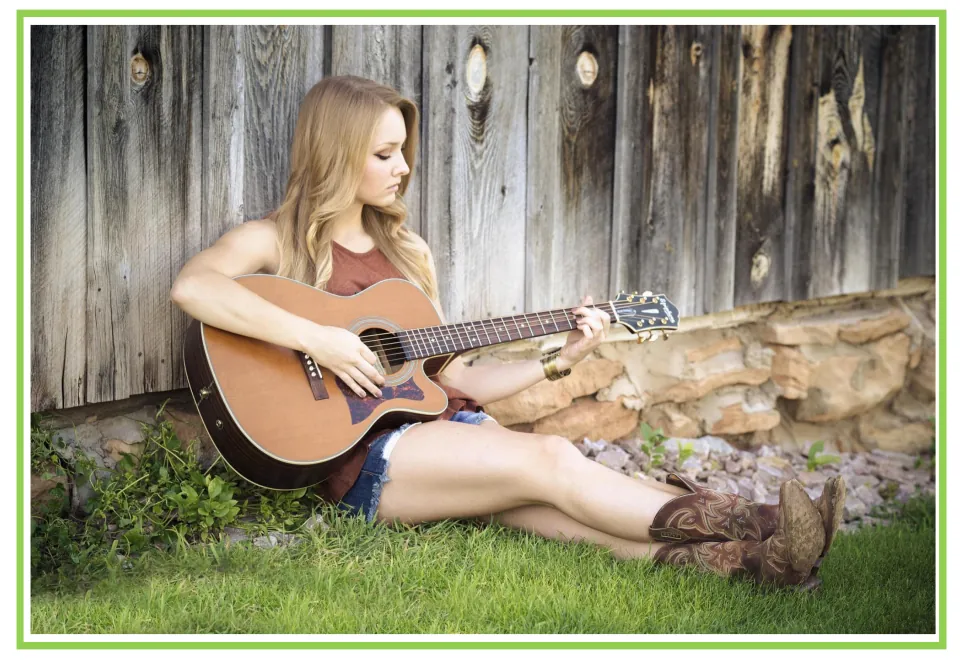 Hobbies writing and discussion prompt card showing a woman seated outdoors playing an acoustic guitar