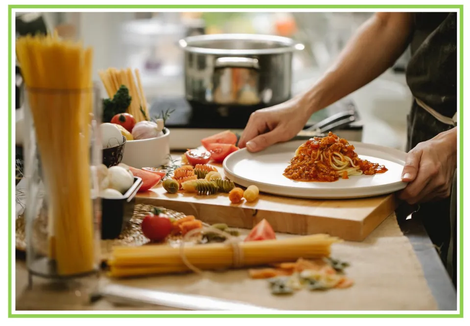 Hobbies writing and discussion prompt card showing a person plating pasta with sauce at a kitchen counter