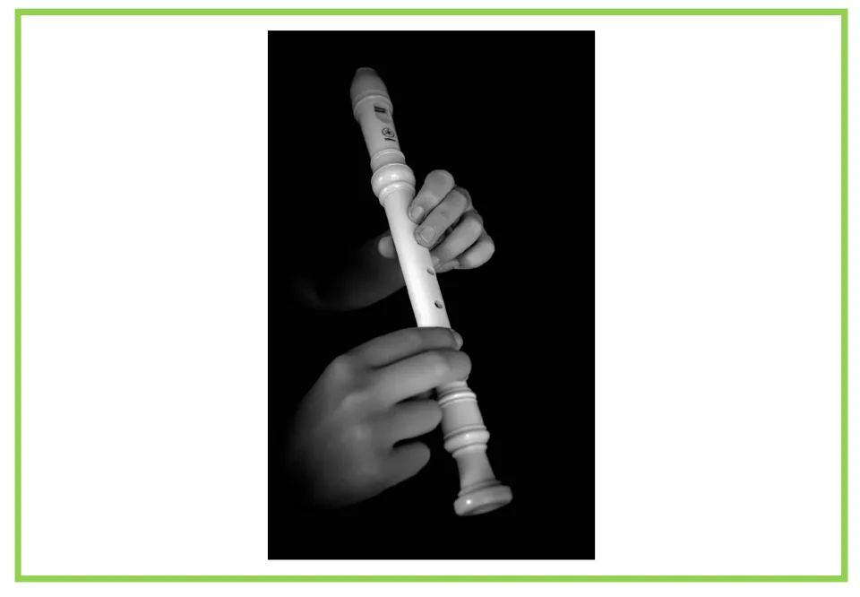 Musical instrument writing and discussion flashcard featuring a recorder held in a person's hands