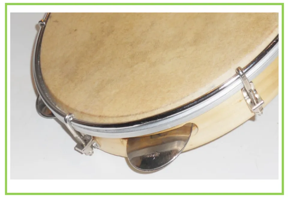 Musical instrument writing and discussion flashcard featuring a tambourine with metal jingles