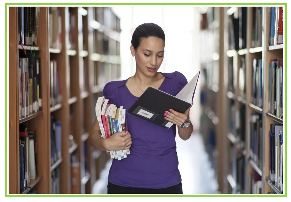 Library study flashcard: a woman in a purple top carries a stack of books and reads a binder, a scene to describe aloud