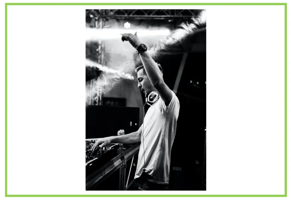 Bar and club discussion flashcard 5: a DJ raises one arm while using a mixer, with headphones around his neck