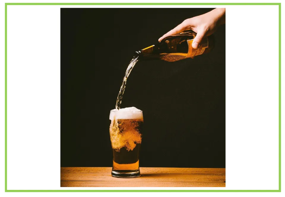 Bar and club discussion flashcard 7: a hand pours beer from a brown bottle into a glass topped with foam