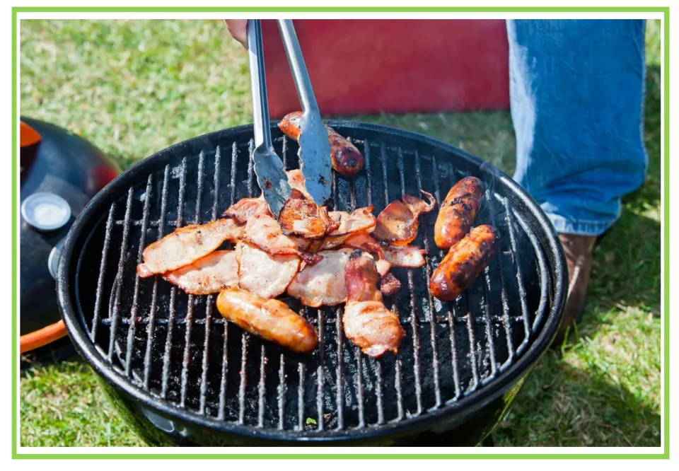 Camping writing and discussion prompt card 9: sausages and slices of meat cooking on a round outdoor grill