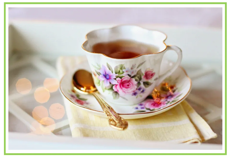 Coffee shop writing and discussion cue card 2: tea in a floral teacup with a matching saucer and spoon