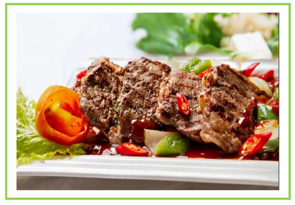 Meals and diet discussion flashcard 5: cooked meat served with peppers and onions on a plate
