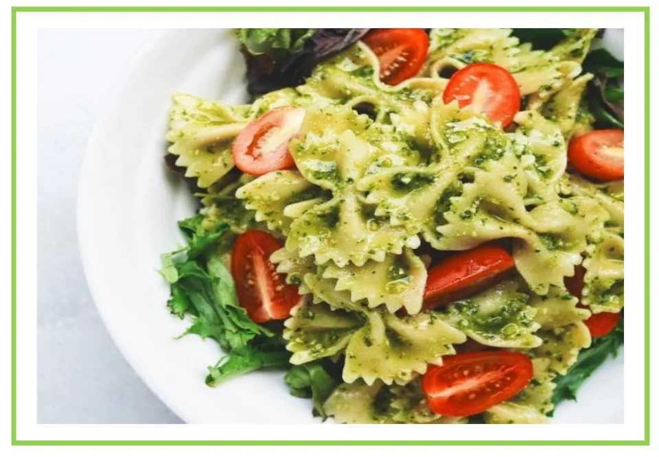 Meals and diet discussion flashcard 7: bow-tie pasta coated in green sauce with tomatoes and leafy greens