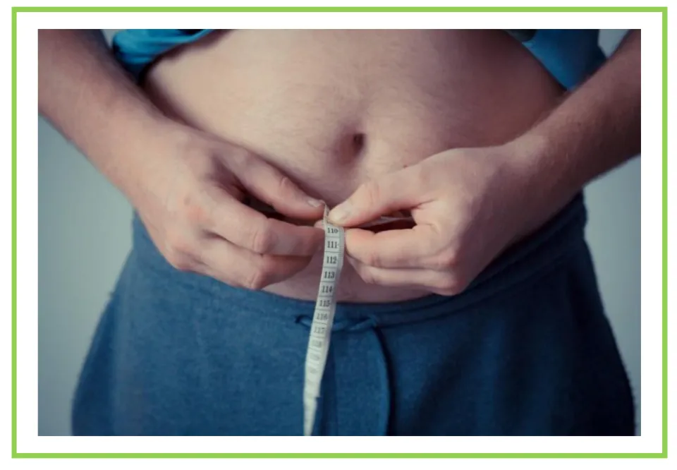 Meals and diet discussion flashcard 9: a person holding measuring tape around their bare waist