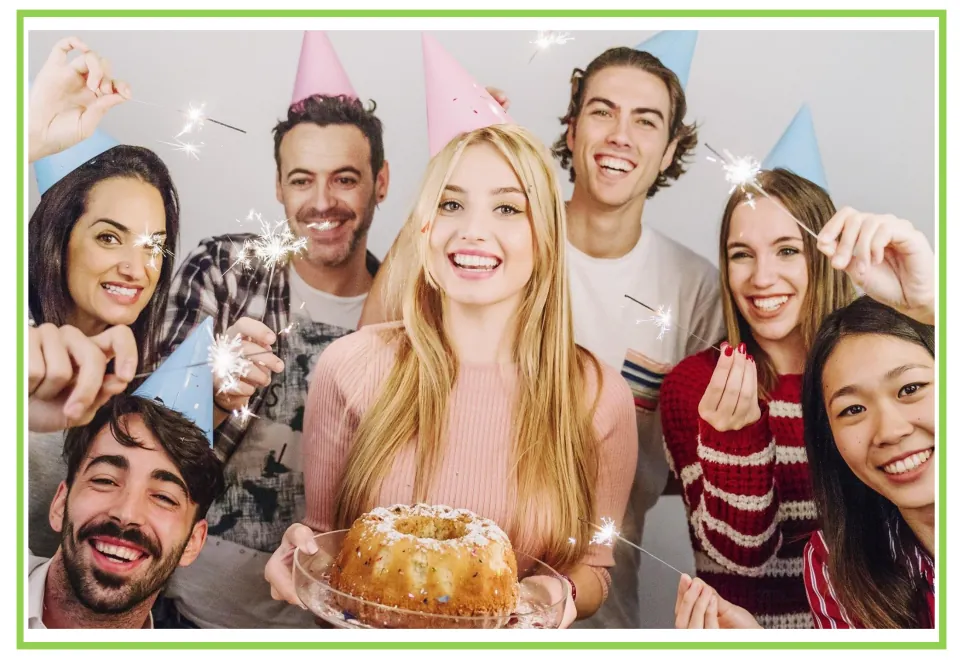Party writing and discussion flashcard 1: a group celebrating with a cake, party hats, and sparklers