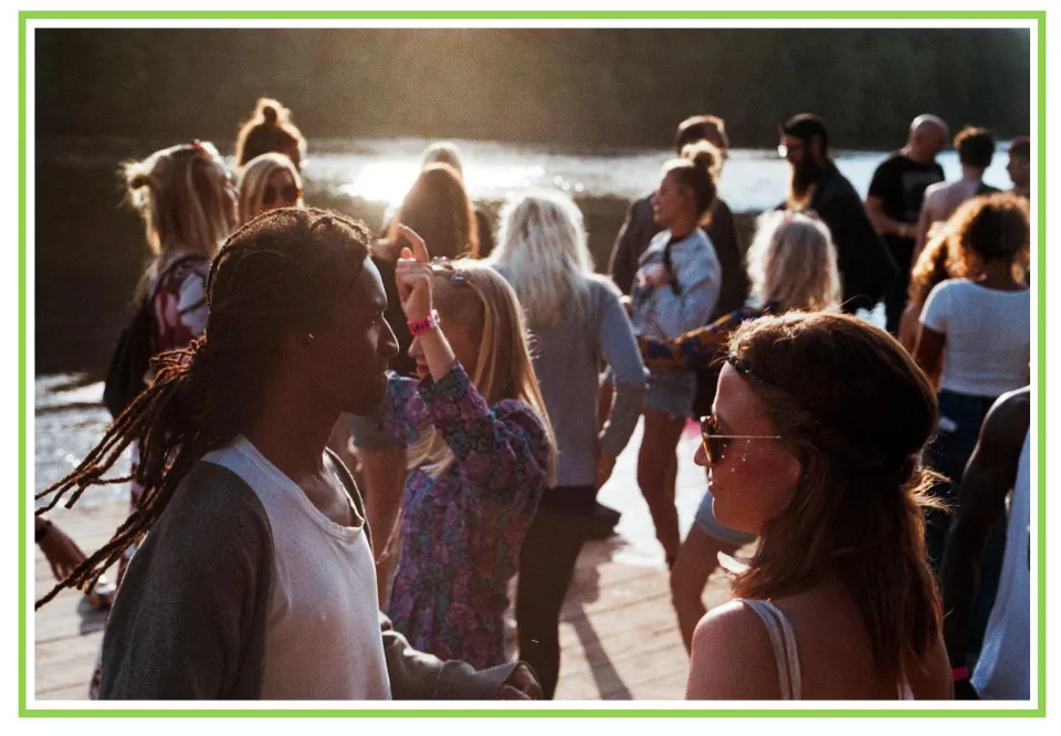 Party writing and discussion flashcard 9: people gather outdoors beside the water, with two in the foreground