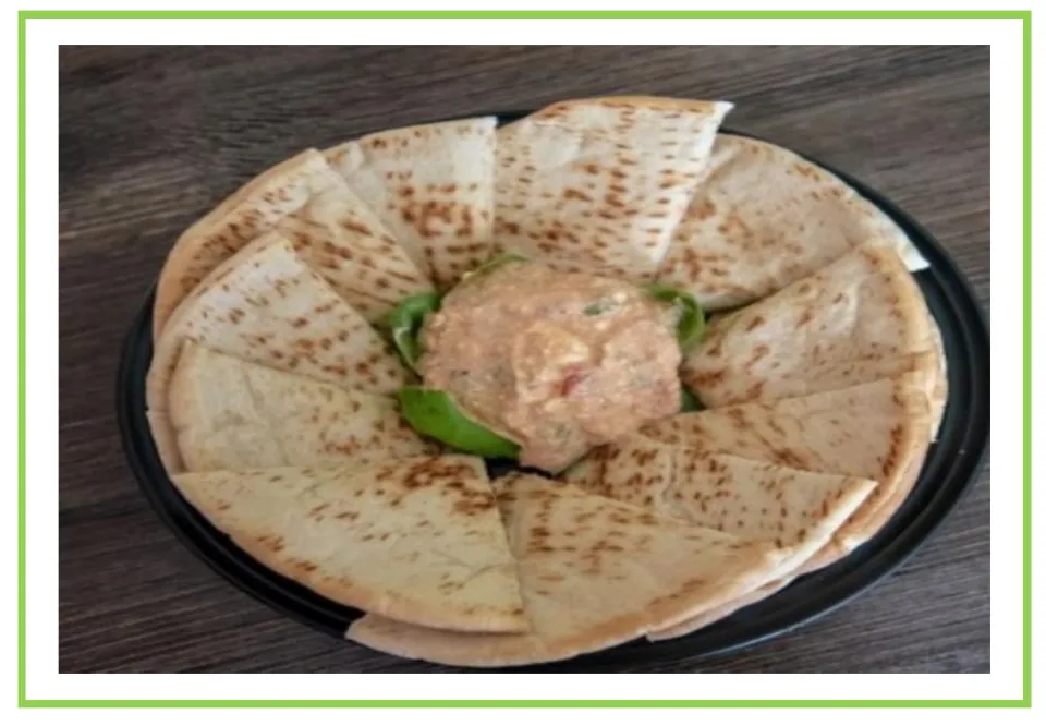 Salty snack flashcard 8 for writing prompts and discussions shows pita bread wedges surrounding a dip.
