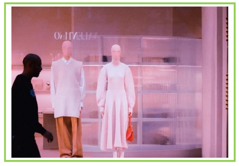 Shopping discussion and writing prompt card 3: a person walking past two mannequins in a store window
