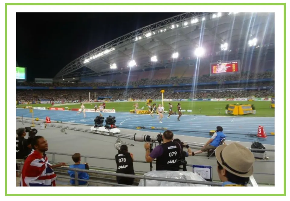 Track racing writing and discussion flashcard showing runners competing in a stadium under bright lights