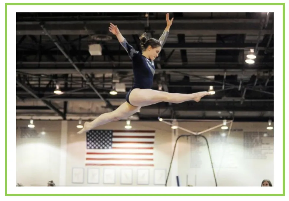 Gymnastics writing and discussion flashcard showing a gymnast airborne with legs split and arms raised
