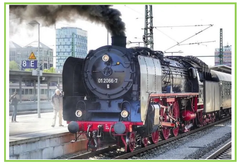 Train writing and discussion prompt card 3: a black steam locomotive releasing smoke at a station