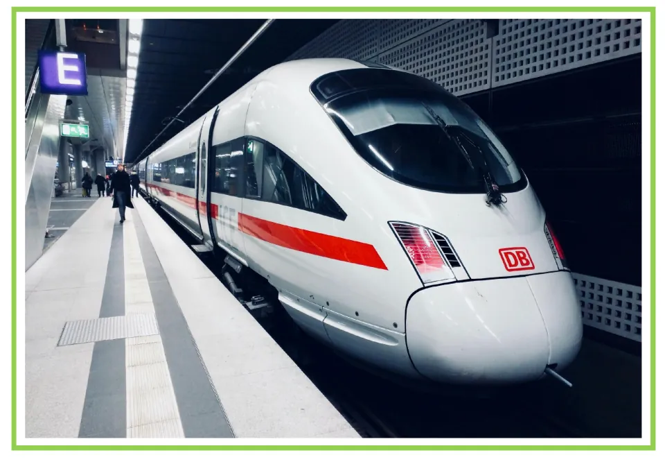 Train writing and discussion prompt card 6: a streamlined white train with a red stripe at a platform